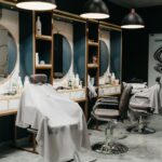 a hair salon with chairs and mirrors and lights
